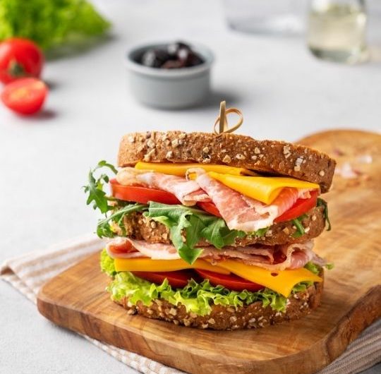 Classic Club-Style Sandwich with Bacon, Cheese, and Tomato
